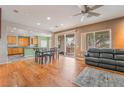 Open floor plan featuring hardwood floors, dining area and sliding door to backyard at 8506 River Ridge Dr, Las Vegas, NV 89131