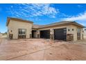 Contemporary home featuring a spacious driveway and a three-car garage with stone accents along the entrance at 8509 Iron Mountain Rd, Las Vegas, NV 89143