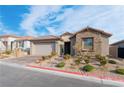 Beautifully landscaped front yard with brick pathway leading to the home's entrance at 8648 Cloverbelle St, Las Vegas, NV 89166