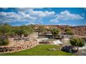 Beautiful landscaped entrance with tiered stone waterfalls and lush greenery welcomes you to the Sun City Mesquite community at 906 Majestic Vw, Mesquite, NV 89034