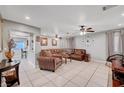 Spacious living room featuring tile flooring, ceiling fans, and comfortable furnishings, perfect for relaxation at 9143 Bucksprings Dr, Las Vegas, NV 89129