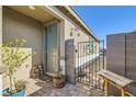 Charming front entrance with stylish decor, a quaint welcome gate, and decorative pavers creating a warm and inviting ambiance at 9698 Pacific Pine St, Las Vegas, NV 89143