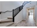 Entryway with view into the house featuring wood-look tile flooring and a carpeted staircase at 12397 Foxtail Run Ave, Las Vegas, NV 89138