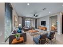 Bright, open living room features modern decor, plush seating, and seamless outdoor access at 12397 Foxtail Run Ave, Las Vegas, NV 89138