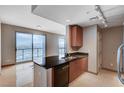 Modern kitchen with granite countertops and stainless steel dishwasher with access to the living space at 200 W Sahara Ave # 3009, Las Vegas, NV 89102