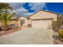 Well-maintained single-story home with desert landscaping, a concrete driveway, and an attached two-car garage at 2386 Amana Dr, Henderson, NV 89044