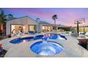 Stunning pool and spa with lounge area, lush landscaping, and a basketball court perfect for outdoor relaxation and recreation at 2768 Tyndrum Ave, Henderson, NV 89044