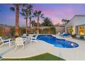 Relaxing pool area with comfortable lounge chairs and lush greenery, offering a perfect outdoor retreat at 2768 Tyndrum Ave, Henderson, NV 89044