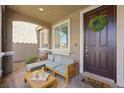 Inviting front porch with stylish seating area and charming decor for a welcoming entrance at 2816 Turnstone Ridge St, Henderson, NV 89044