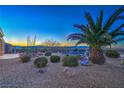 Spacious backyard featuring desert landscaping, a fountain, and beautiful mountain views at 3002 Hickory Valley Rd, Henderson, NV 89052