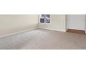 Spacious living room with neutral carpeting and a bright window allowing natural light at 317 E Van Wagenen St, Henderson, NV 89015