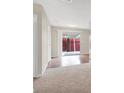 Bright living area with sliding glass door, hardwood flooring and neutral walls at 317 E Van Wagenen St, Henderson, NV 89015