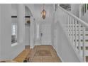 Bright foyer with tile flooring, staircase, and decorative chandelier at 3215 Lubec Valley Ln, Henderson, NV 89074