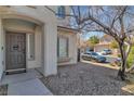 Inviting front entrance featuring a neutral color scheme and low-maintenance desert landscaping at 3215 Lubec Valley Ln, Henderson, NV 89074