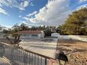 Spacious property features a large driveway and a detached garage at 3456 Happy Ln, Las Vegas, NV 89120