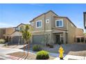 Two-story home with a two car garage and simple front yard landscaping at 3807 Andorian Ave, North Las Vegas, NV 89084