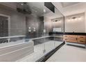 Contemporary bathroom showcasing a glass-enclosed shower, soaking tub, and stylish vanity at 3892 Pasilla Ave, Las Vegas, NV 89118