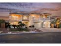 Charming two-story home with a well-manicured lawn and a three-car garage at 4384 Grey Spencer Dr, Las Vegas, NV 89141