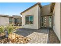 Home entrance featuring a stylish front door, desert landscaping and a stone paver walkway at 4772 Se Argent Hills Ave, Pahrump, NV 89061