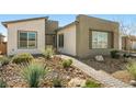 Stunning home showcasing desert landscaping with walkway to front door at 4772 Se Argent Hills Ave, Pahrump, NV 89061
