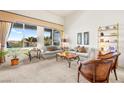 Inviting living room featuring large windows, plush seating, and a neutral color palette at 482 Bonnie Brook Pl, Henderson, NV 89012