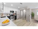 Well-lit kitchen boasts updated stainless appliances, ample countertop space, and pristine white cabinets at 4842 Plata Del Sol Dr, Las Vegas, NV 89121