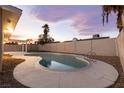 Backyard features a sparkling private pool, surrounded by a concrete deck and secure block fencing at 4842 Plata Del Sol Dr, Las Vegas, NV 89121