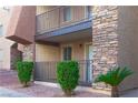 Condo exterior featuring stone accents, tidy landscaping, and private patio with railing at 5000 Indian River Dr # 475, Las Vegas, NV 89103