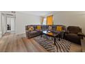 Inviting living room with a plush gray sectional sofa, wood-look floors, and a stylish rug at 5180 Indian River Dr # 355, Las Vegas, NV 89103