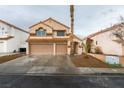 Two-story home with a neutral exterior, a three-car garage, and a landscaped front yard at 71 Sea Holly Way, Henderson, NV 89074