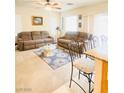 Spacious living room with carpet, ceiling fan, and two couches at 8036 Maple Park St, Las Vegas, NV 89131