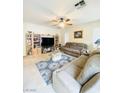 Comfortable living room with a ceiling fan, carpet, and media center at 8036 Maple Park St, Las Vegas, NV 89131