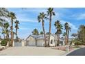 A spacious home features a wide driveway leading to an attached two-car garage at 8112 Golfers Oasis Dr, Las Vegas, NV 89149