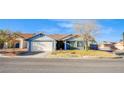 Charming single-story home featuring a well-maintained lawn, desert landscaping, and a two-car garage at 819 Teal Wing Way, Henderson, NV 89002