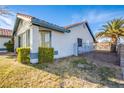 Charming single-story home featuring a well-maintained lawn, desert landscaping, and a gated side yard at 819 Teal Wing Way, Henderson, NV 89002