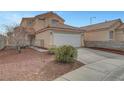 Two-story home featuring a two-car garage and low-maintenance desert landscaping at 9177 Bucksprings Dr, Las Vegas, NV 89129