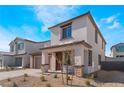 Contemporary two-story home with desert landscaping, brick trim, and a welcoming front porch at 9333 Observatory St, Las Vegas, NV 89143