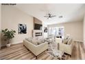 Cozy living room with modern fireplace, ceiling fan, and bright natural light at 10205 Birch Bluff Ln, Las Vegas, NV 89145