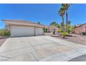 Long driveway and three-car garage of a single-story home with desert landscaping at 1596 Fieldbrook St, Henderson, NV 89052