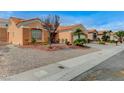 Well-maintained home with desert landscaping and a sidewalk, next to neighboring homes at 1925 Hot Oak Ridge St, Las Vegas, NV 89134