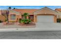 Attractive single-story home featuring desert landscaping and a driveway leading to the attached two-car garage at 1925 Hot Oak Ridge St, Las Vegas, NV 89134