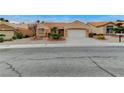 Inviting single-story home with tidy landscaping, a neutral color, and a two-car garage at 1925 Hot Oak Ridge St, Las Vegas, NV 89134