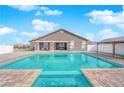 Backyard pool featuring a jacuzzi and covered patio sitting area at 2171 Deadwood St, Pahrump, NV 89048