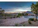 Paved driveway with desert landscaping, beautiful mountain views, and a glimpse of the neighborhood at 294 Besame Ct, Las Vegas, NV 89138