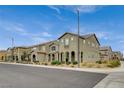 Attractive row of stucco townhomes in a well-kept neighborhood, featuring tiled roofs and neat landscaping at 3165 Brynley Ave, Henderson, NV 89044