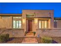 Inviting front entry with stone facade, brick walkway, and modern lighting creates a welcoming ambiance at 4273 Sunrise Flats St, Las Vegas, NV 89135