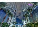 Night shot of high-rise condominium towers with palm trees and porte cochere at 4525 Dean Martin Dr # 911, Las Vegas, NV 89103