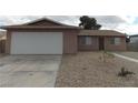 Cozy single-story home featuring a two-car garage and desert landscaping at 4601 Diamond Head Dr, Las Vegas, NV 89110