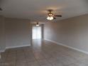 Open living room with tile flooring, ceiling fans, and a sliding glass door at 4601 Diamond Head Dr, Las Vegas, NV 89110