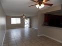 Bright living room featuring tile floors, ceiling fans, and an open layout to the kitchen at 4601 Diamond Head Dr, Las Vegas, NV 89110